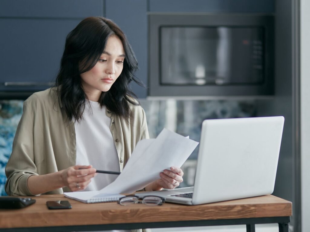 Person reading documents laptop, related to how to compare pet insurance plans